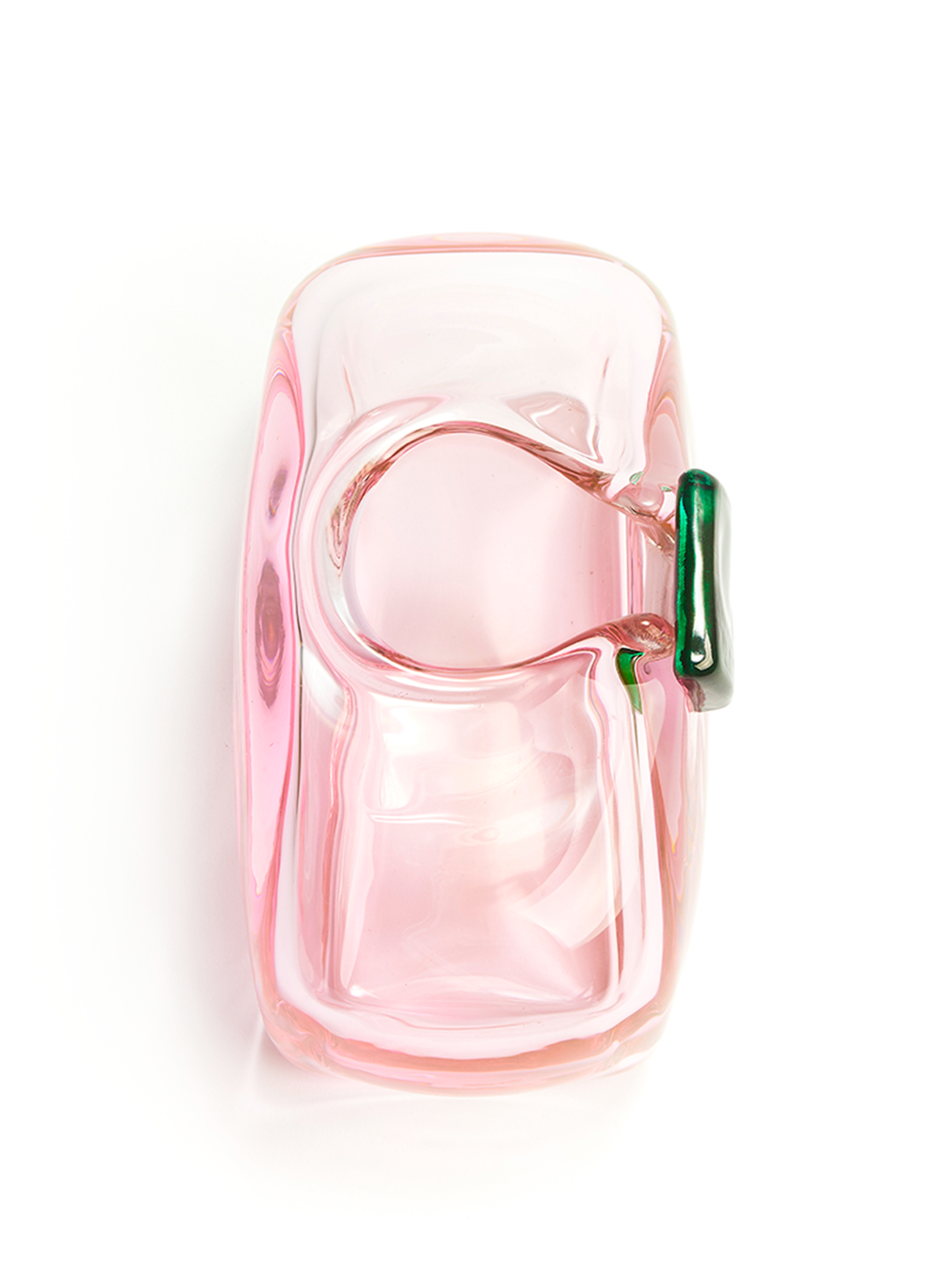 top view of a handmade rectangular glass object in a light pink color with a dark green detail