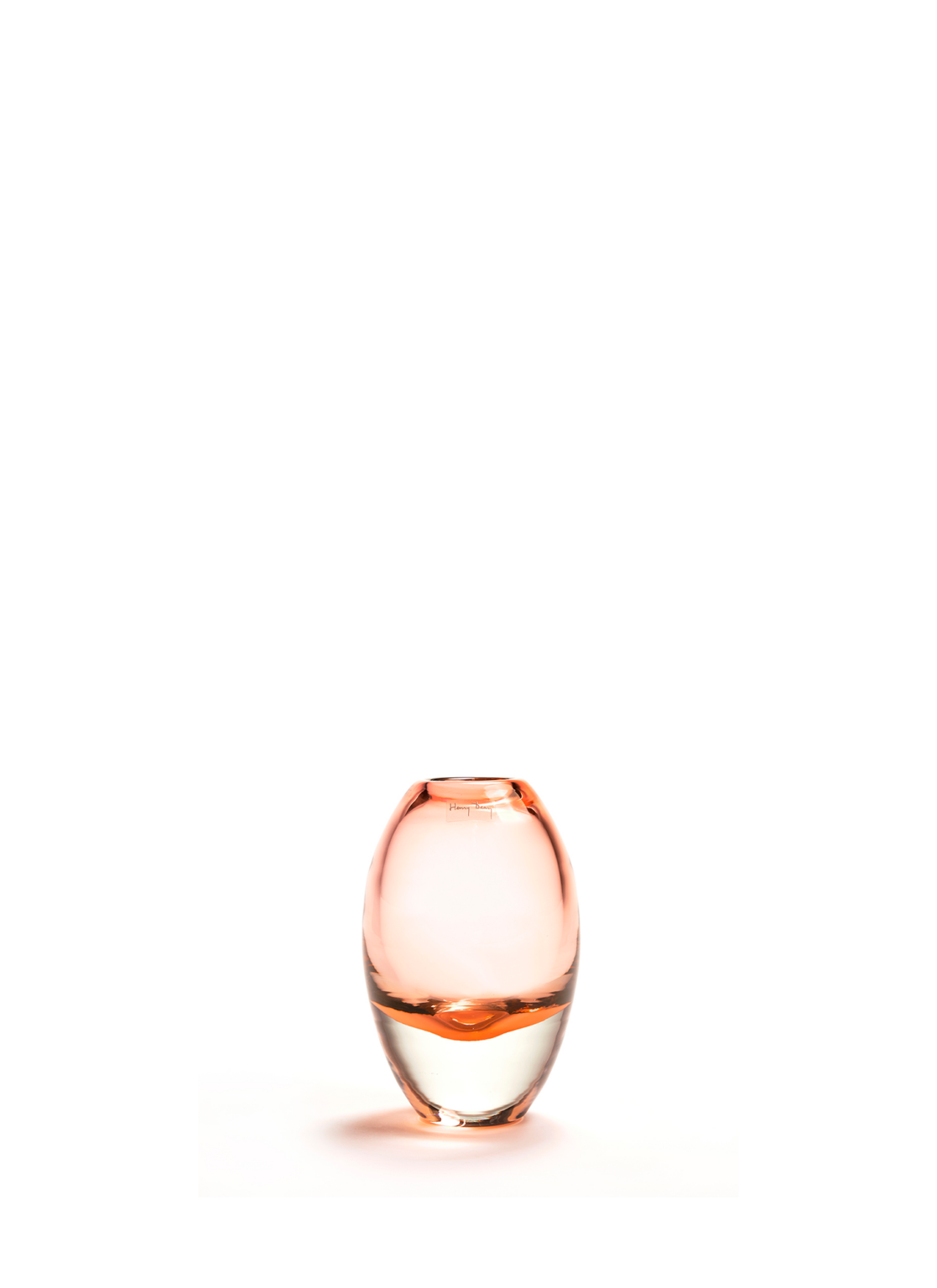 Oval shaped handmade glass vase in a salmon color